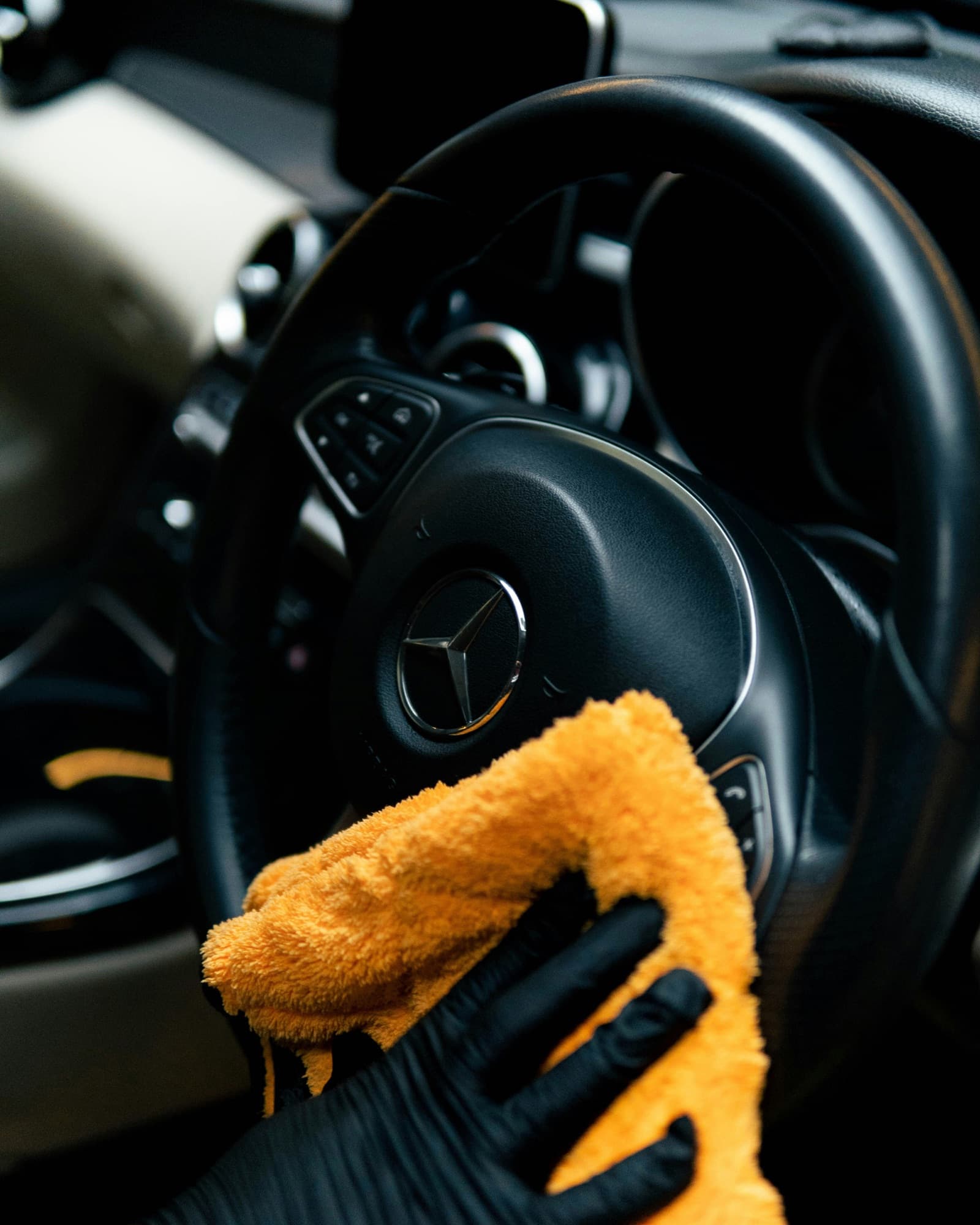 Wiping down a steering wheel and interior trim with a microfiber cloth
